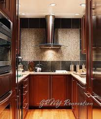 tiny kitchen with cherry cabinets and