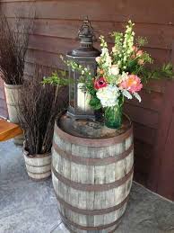 Since you have tons of beautiful choices, it can be difficult to pick the best product to purchase. Entrance Centerpiece Atop A Whiskey Barrel With A Lantern Our In House Floral Designer Has A Great Talen Front Porch Decorating Barrel Decor Wine Barrel Decor