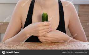 Woman hands holding cucumber and play with it. Safe sex concept. Stock  Photo by ©familylifestyle 193011746
