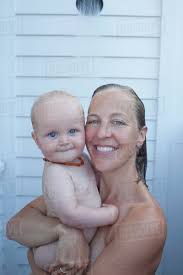 It is considered rude to ask someone to throw you a baby shower. Mid Adult Woman Having Shower With Her Baby Son 12 17 Months Stock Photo Dissolve