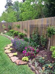 As far as small backyard landscape ideas on a budget, this is one of the easiest, most affordable ideas out there. This Is A Nice Way To Use Black Fencing From An Old House Against A Stockade Fence Backyard Landscaping Designs Garden Yard Ideas Front Yard Landscaping