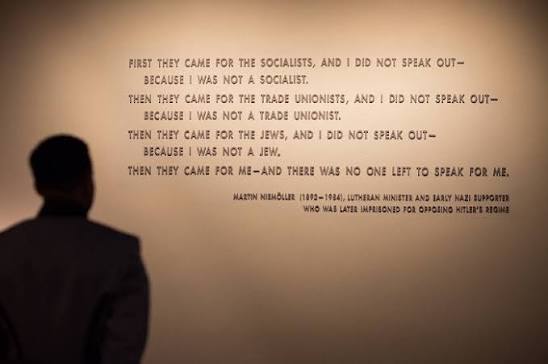 A visitor reading the Martin Niemöller quotation | Holocaust Encyclopedia
