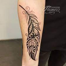The artist has done a great job of recreating the flowing state of a feather. Tribal Feather Tattoo Flaneur S Tattoo Studio Facebook