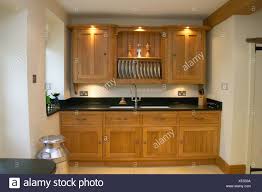 lighting above wooden kitchen cupboards