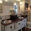 This luxurious boho chic bathroom has a beautiful oil painting on the wall above the bathtub. 3