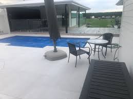 Ideas for paving around pools using pool pavers & pool coping. White Quartzite Dropface Pool Coping W Matching Paving Natural Stone Imports