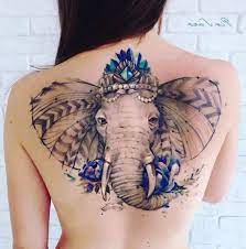 This Large Elephant Tattoo On The Beautiful Back Of A Woman Reflects Power Strength And Peace Symbolic Tattoos Tattoos Elephant Tattoos