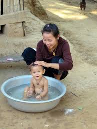 Water entering the middle ear could increase the risk of a middle ear infection. Laos Village Ethnic Lao Baby Bath Toilet Family Tenderness Pikist