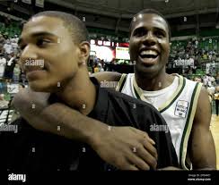South Florida's Melvin Buckley, right, celelbrates with injured teammate  Chris Howard after South Florida upset Georgetown, 63-56, in an NCAA  college basketball game Saturday night March 4, 2006 at the Sun Dome