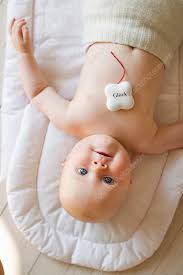 Baby Girl With Lucky Charm Stock Image F010 0877 Science Photo Library