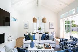 A round taupe mirror is mounted on a serena & lily feather wallpaper covered wall above a rh baby and child jameson wide dresser and topper set. Serena Lily Design Ideas