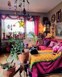 The room is accessorized with a rattan ceiling light, macrame plant hangers, plenty of plants, and and a patterned plush rug. Pin On Decoration Plants