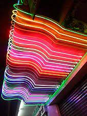 Like the neon signs we see today, they were powered by electrodes on either end of the glass chamber that would run a current through the gas inside, causing it to light up. Neon Sign Wikipedia