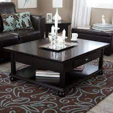 A black live edge coffee table styled with coffee table books and a mercury glass etched vase sits on a black rug. Minimalistfurnituredesign Com Coffee Table Living Room Coffee Table Home Decor