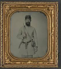 Corporal John Agee Booker of Co. D, 21st Virginia Infantry Regiment, in  uniform with Bowie knife, flintlock pistol, and tin drum canteen with his  name