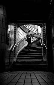 Grayscale Photo Of Man Walking Upstairs Photo Free Black And White Image On Unsplash Walking Up Stairs Stairs Guy Pictures