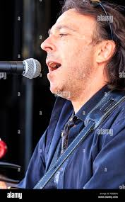 Close up of Daniel Warwick from the Indie rock group, Feral Ghost, singing  into microphone while