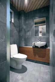 A creative small bathroom with a green wall, terrazzo flooring and wall, a wooden floating vanity and a coral bowl sink. 30 Small Modern Bathroom Ideas Deshouse
