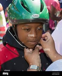 Detroit, Michigan USA. Children get free bicycle helmets at a Back to  School Festival sponsored by Greater Grace Temple, a 6,000-member  Pentecostal church. The annual festival features games, food, health  screenings, haircuts,