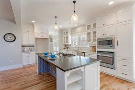An Open Floor Plan Kitchen With Shaker Style Cabinets Built In Appliances And Bookcase Cabinets On The Farmhouse Kitchen Dream Pantry Open Floor Plan Kitchen