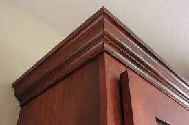 Normally the cabinet is going to be installed and up on the wall, however it's easier for you to see us install the crown molding if we do it on a work bench. How To Install Crown Molding On Kitchen Cabinets