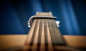 Acoustic guitar with a capo on the fretboard