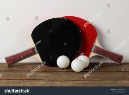 Two Ping Pong Rackets Rackets For Table Tennis And A Ball On A Brown Wooden Table And Against The Background Of The Wa Table Tennis Sports Games Wooden Tables