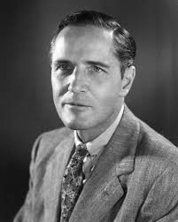 A black and white photo of a man in a suit. American Embassy, Paris,  France, Marshall Plan photogrpaphs