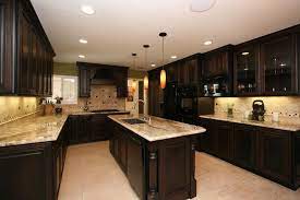 A stainless steel range and oven is flanked by classic white cabinets with nickel hardware. 21 Dark Cabinet Kitchen Designs Cheap Kitchen Remodel Brown Kitchen Cabinets Kitchen Cabinet Design