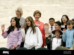 First lady Laura Bush, center, and Secretary of the Interior Gale Norton,  second row left, take the National Park Service Junior Ranger oath during a  ceremony at the Jefferson Memorial Thursday, April