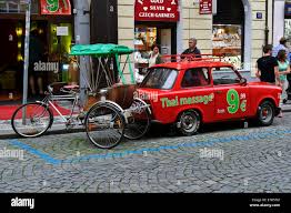 A red car and rickshaw outside a Thai Massage Shop in City of Prague, Czech  Republic Stock Photo - Alamy
