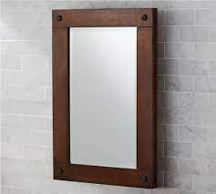 Made with a wooden frame in a white hue, it features a mirrored door that conceals adjustable shelves. Benchwright Recessed Medicine Cabinet Pottery Barn