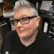 56….have always had my hair short….shows off my silver! By the way I have  been a professional tattoo artist for over 30 years....hence the piercings  n tattoos...don't like em don't look !