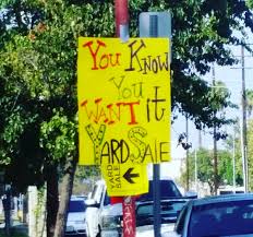 Yard sale with household junk and odds and ends objects for sale on display tables on a suburban garage driveway. 15 Of The Funniest Yard Sale Signs Found On Instagram Garage Sale Blog
