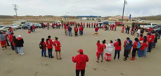A woman holds a sign that says no more stolen sisters on red dress day in edmonton. Y8mfw4ul9wox6m