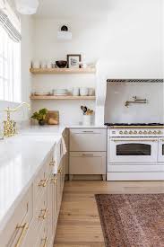 Black transitional kitchen design with contemporary black cabinets with stainless steel hardware along with stainless steel appliances and dark wood floor. 17 Gorgeous Greige Kitchen Cabinets Chrissy Marie Blog
