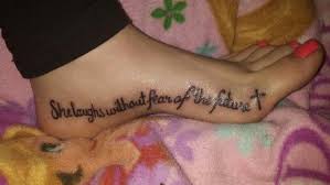 Her tattoo say she is clothed with strength and dignity as shes getting it in the butt. Foot Tattoo Proverbs 31 25 She Is Clothed In Strength And Dignity And She Laughs Without Fear Of The Future Tattoo Fo Future Tattoos Tattoos Foot Tattoo