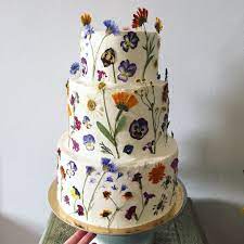 Whether sprinkled on a salad, incorporated into a cocktail or ice cubes, or candied for a cake, these blooms promise to add an ambrosial touch to your seasonal entertaining. Beautiful Pressed Flowers Wedding Cake Beautiful Wedding Cakes Summer Wedding Cakes White Wedding Cake