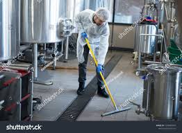 Industrial Cleaning Service Professional Cleaner Wearing Protection Uniform Cleaning Floor Of Productio Professional Cleaners Cleaning Service Cleaner Service