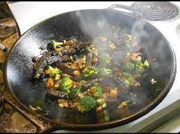 American Wok Hei Stir Frying On An Electric Stove In A Cast Iron Wok Cast Iron Wok Wok Recipes Cooking