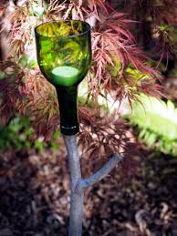 The dripping wax on the bottles will bring a warm and romantic touch to the atmosphere. Use Empty Wine Bottles In The Garden Again 20 Clever Ideas Wine Bottle Outdoor Wine Bottle Garden Empty Wine Bottles