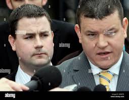 Chris Ward, 26, (left) with his solicitor Niall Murphy (right) outside  Belfast Crown Court, he was today cleared of the 26.5 million Northern Bank  robbery in Belfast Stock Photo