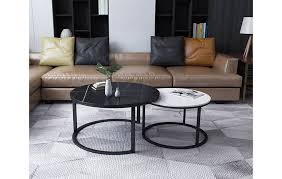 This pair of nesting coffee tables pairs textured surfaces with airy, curving silhouettes, giving you the ability to balance the bold contours of your sofa and chairs with some contrast. Modern Design Round Sintered Stone Nesting Coffee Tables And Side Tables Home Furniture