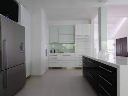 The White Lacquered High Gloss Kitchen Cabinets Look Complete With Complimenting Silver Colored Roller S Gloss Kitchen Cabinets Kitchen Cabinet Handles Kitchen