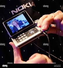 A visitor holds the new Nokia N92, a ...