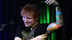 A star with festina lente written under it covered by leaves. Ed Sheeran S Tattoo Artist Ed Sheeran S Tattoos Are Terrible
