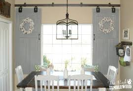Barn Shutters Over Interior Windows The Pink Tumbleweed Used Old Doors As A Sliding Barn Door Style Wi Barn Door Window Interior Barn Doors Interior Windows