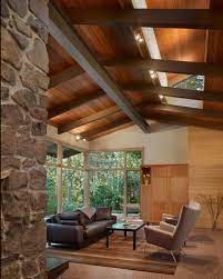 A true vaulted ceiling generally depicts different wall heights on either side of the sloping ceiling, in contrast with a cathedral ceiling, which usually for a traditional colonial vs craftsman home you use a tray ceiling and shorter wood panels. Contemporary Living Room With Wood Paneled Vaulted Ceiling Hgtv