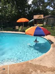 Relaxation Station Swimming Pool Table And Stools Aughog Products Beach Umbrella Sand Anchors Sandbar Anchors And More Pool Umbrellas Relaxation Station Backyard Pool Designs