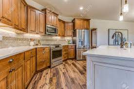 Check spelling or type a new query. Lovely Kitchen With Brown Cabinets And White Island Stock Photo Picture And Royalty Free Image Image 150591017